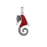 Bold sterling silver seahorse pendant with coral inlay, artisan-crafted for tropical ocean-inspired style.
